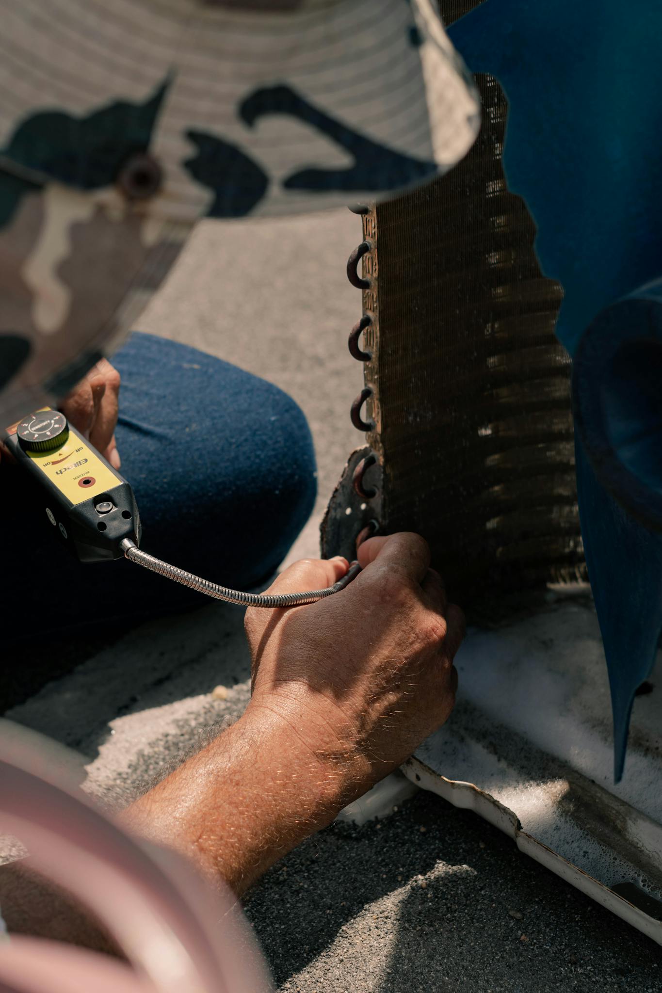 Technician Repairing An Air Conditioner Unit With